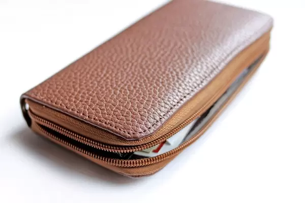 Close Up Photo of Opened Brown Purse on White Background