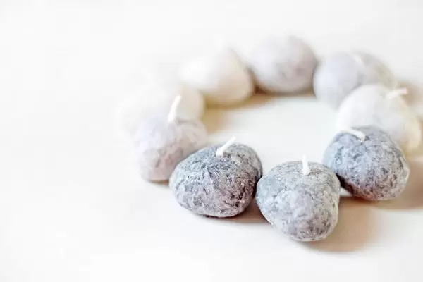 Close Up Photo of Stone Candles in a Circle on White Background