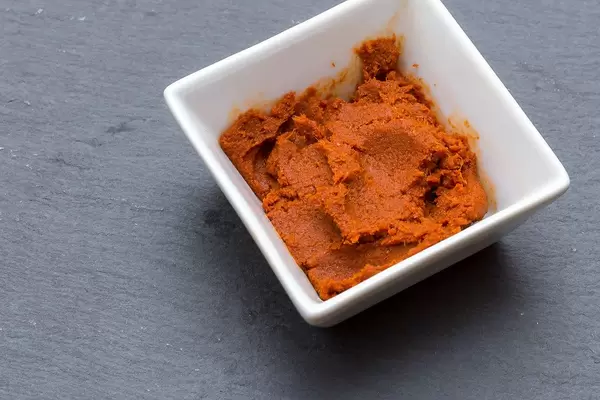 Close Up Photo of Very spicy Massaman Curry Paste in a small White Bowl on Black Table
