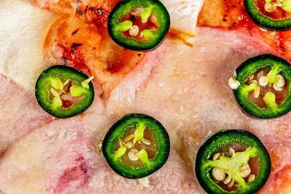 Close-up, pizza with green chili jalapeno slices