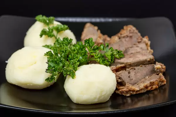 Close-up, potato balls with liver slices and parsley
