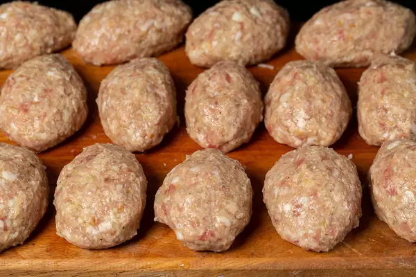 Close-up, raw cutlets on a wooden kitchen board