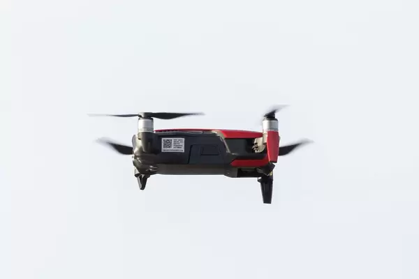 Close up red and black drone hovering in the air