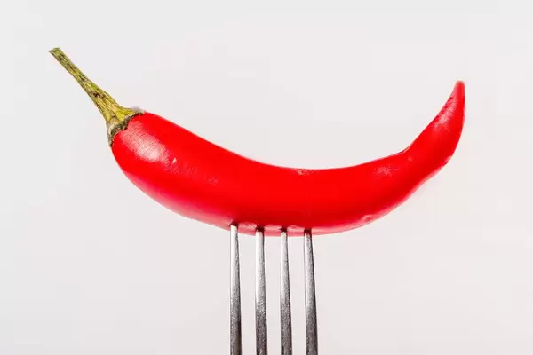 Close-up, red hot chili pepper on a fork