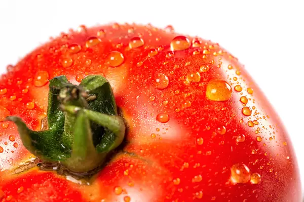 Close-up, ripe red tomato with water drops