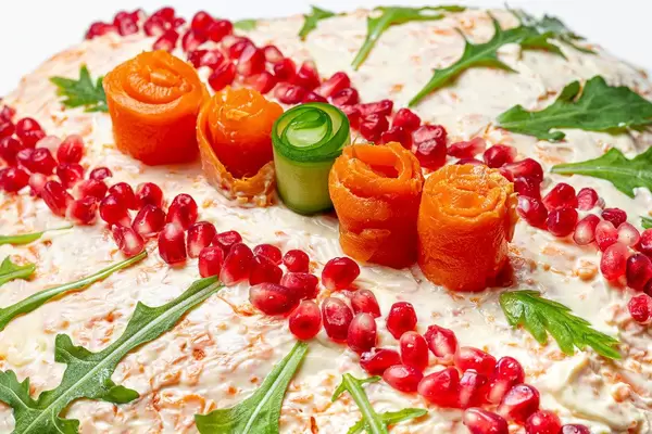 Close-up salad decorated with pomegranate seeds, arugula, carrot and cucumber (Flip 2020)