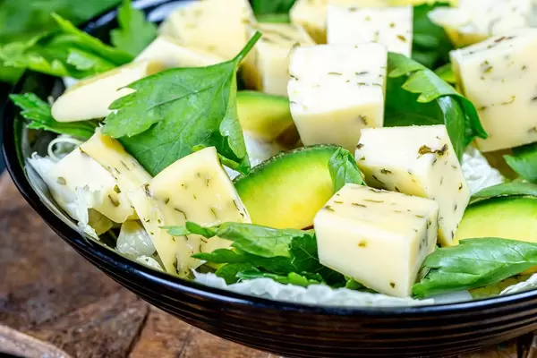 Close-up salad with spicy cheese, avocado and parsley leaves (Flip 2020)