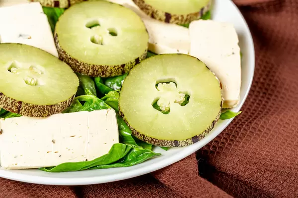 Close-up, salad with spinach, cheese and pepino fruit