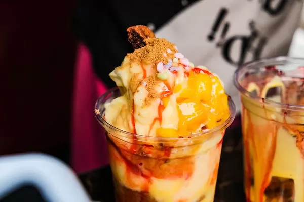 Close up shot of a mango smoothie with toppings (Flip 2019)