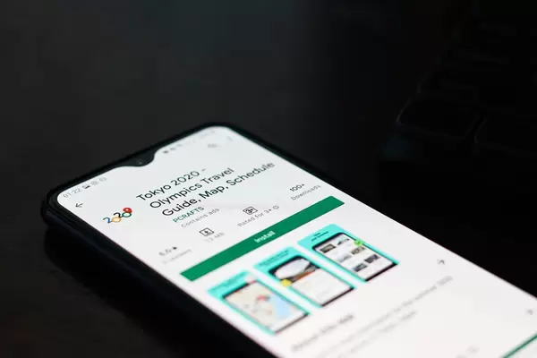 Close-up shot of an app - Tokyo 2020 - Olympics Travel Guide, Map, Schedule on smartphone