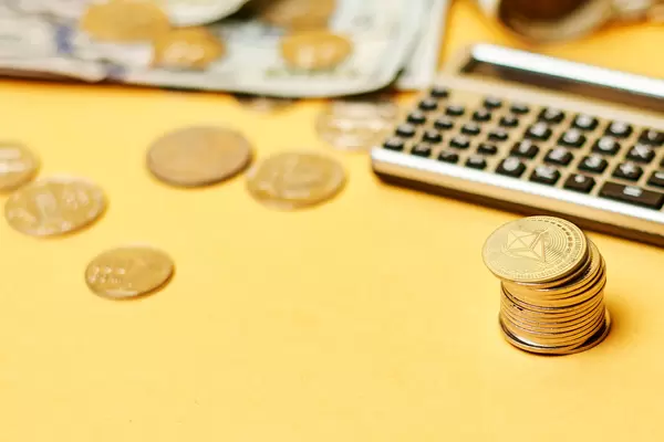 Close-up shot of calculator, money and coins