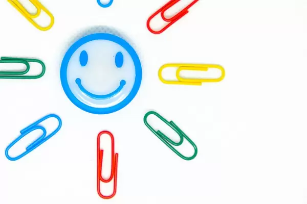 Close up shot of smiley magnet with paperclips