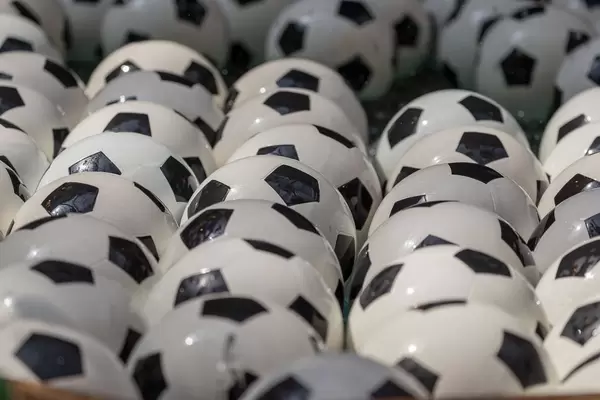 Close-up shot of soccer balls in a fountain
