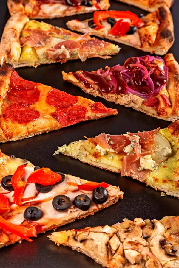 Close-up, slices of different types of pizza. Fast food delicious background