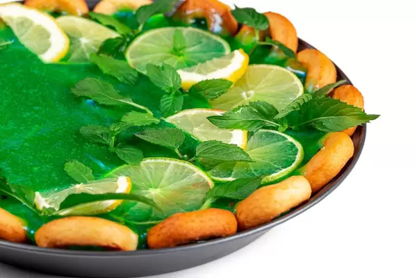 Close-up, slices of lime, lemon with mint leaves on a pie