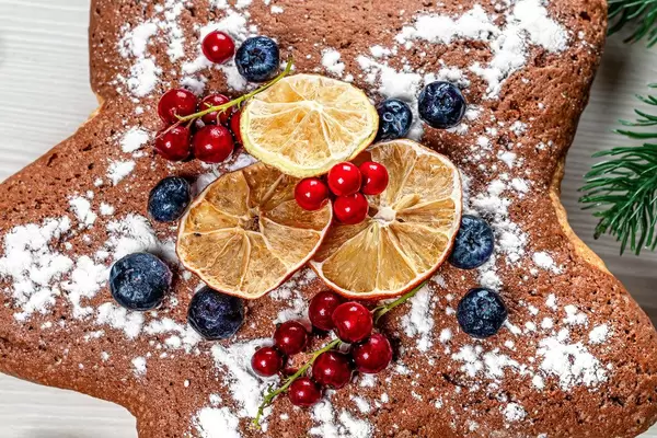Close-up sponge cake with berries and dried citrus slices (Flip 2019)