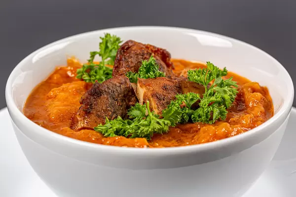 Close-up, thick vegetable soup with carrots, zucchini, chicken fillet and parsley