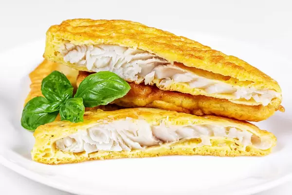 Close-up, tilapia fillet in batter on a white plate