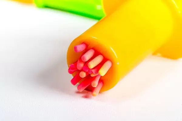 Close-up, toy pastry syringe and dough
