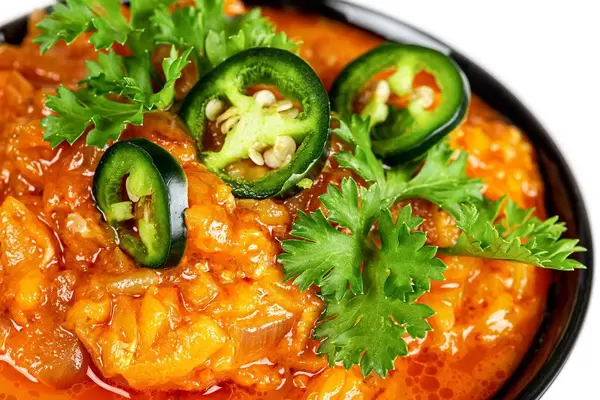 Close-up, vegetable stew with chunks of green hot pepper