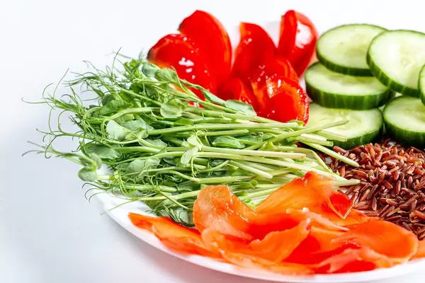 Close-up vegetarian meal with fresh vegetables, pea sprouts and pickled ginger