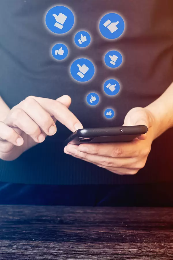 Close-up view of a woman using social media network on mobile phone