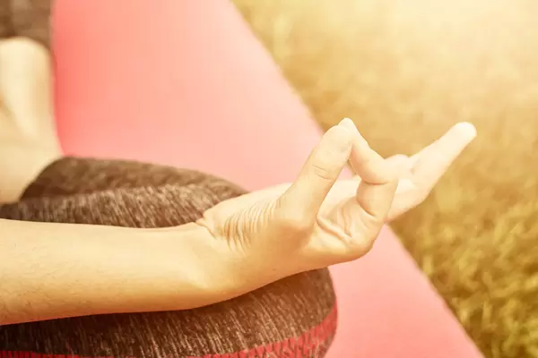 Close-up view of a young female practicing yoga pose