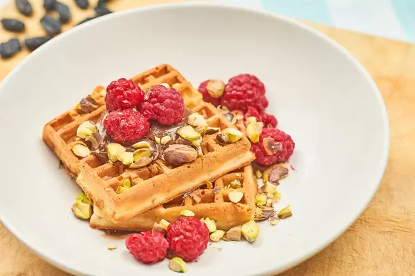 Close-up view of Belgian breakfast with waffles and fruits