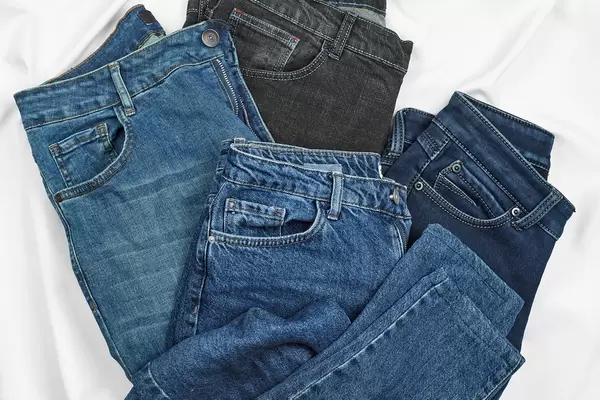 Close-up view of four stylish jeans