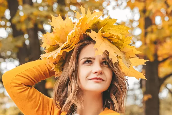Close-up, woman wearing a wreath of autumn leaves
