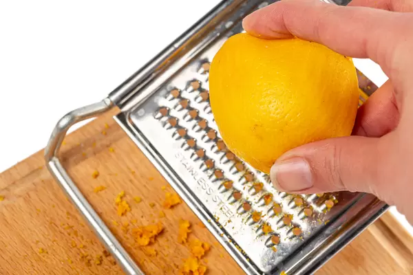 Close-up, women grating lemon zest