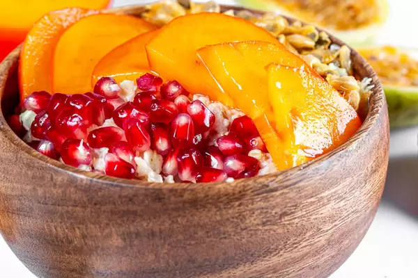 Close-up, wooden bowl with oatmeal and fruit
