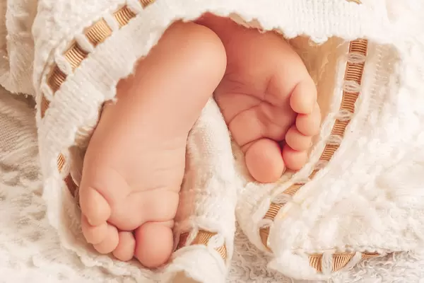 Close view of baby's feet in a white cloth