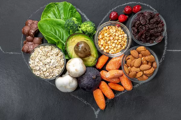 Closeup chalked heart on black background filled with healthy products (Flip 2019)