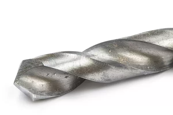 Closeup macro image of metal drill above white background and copy space