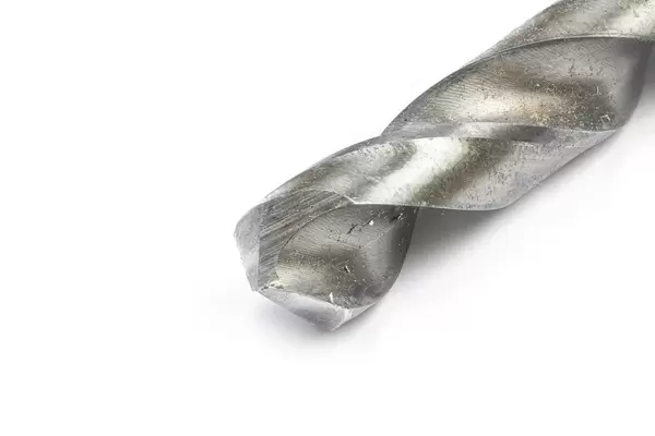 Closeup macro image of metal drill above white background