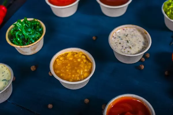 Closeup of appetizer sauces. Pumpkin and mango sauce (Flip 2019)