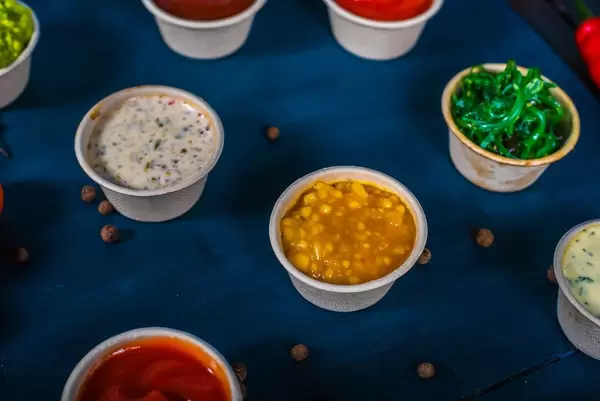 Closeup of appetizer sauces. Pumpkin and mango sauce