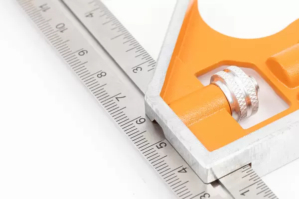 Closeup of Combination Square above white background with copy space