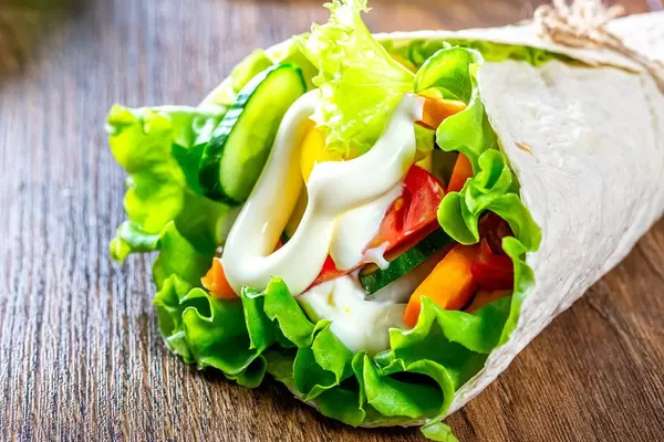 Closeup of cone - pita bread with vegetables and sauce
