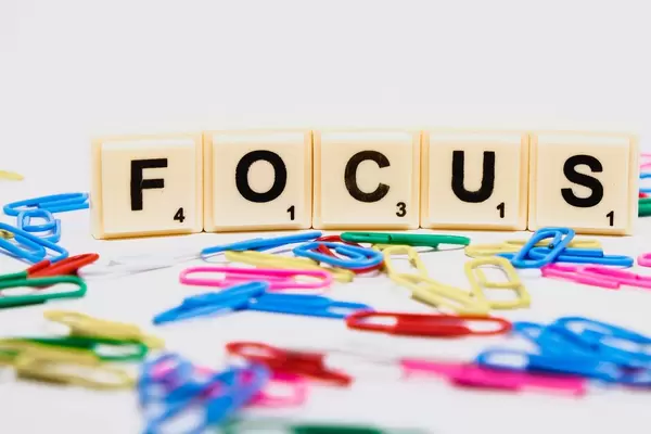 Closeup of Focus text and paperclips on white background