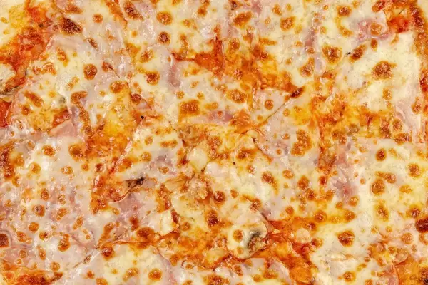 Closeup of Fresh Pizza with Ham and Mushrooms