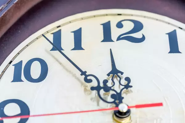 Closeup of hands on clock face