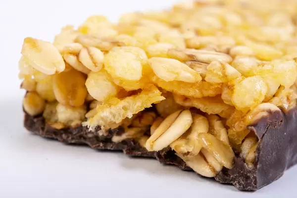 Closeup of Healthy Cereal Bar with Cranberries and Milk cream