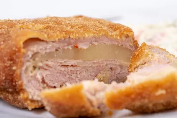 Closeup of Stuffed and breaded Pork Meat with Cheese (Flip 2019)