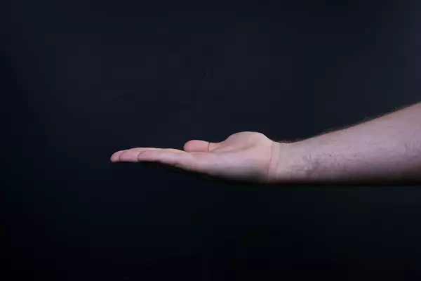 Closeup shot of male hand isolated on black background