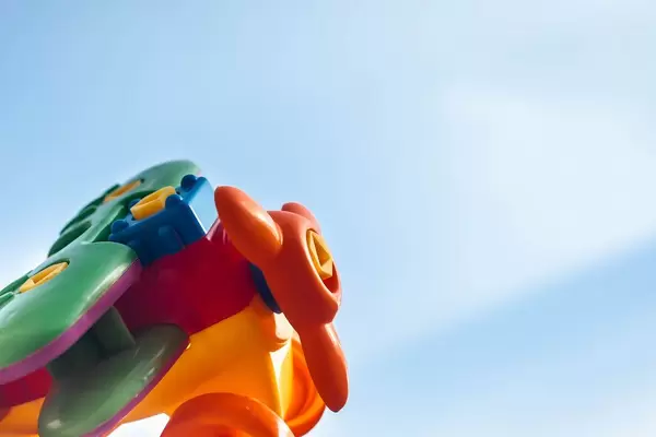 Closeup view of plastic toy plane against clear blue sky