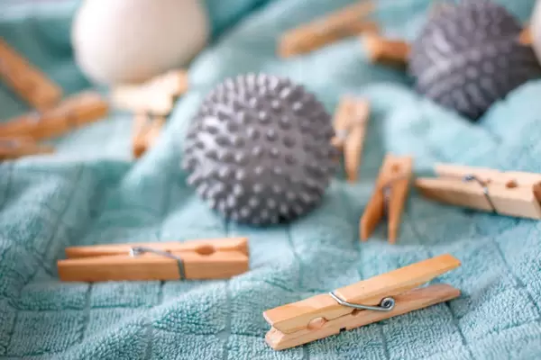 Clothes pins and spiky massage balls on a bath towel