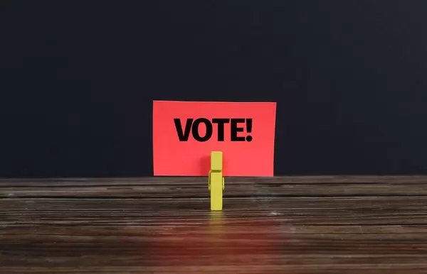 Clothespin holding red paper with Vote text