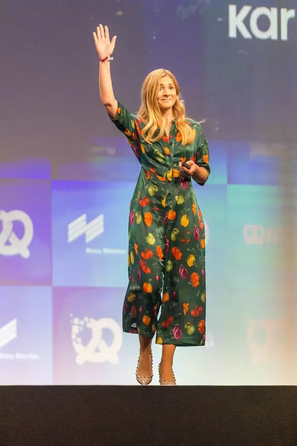 Co-Founder Elsa Bernadotte of first zero food waste generation app Karma, waves on stage at founders event in Germany